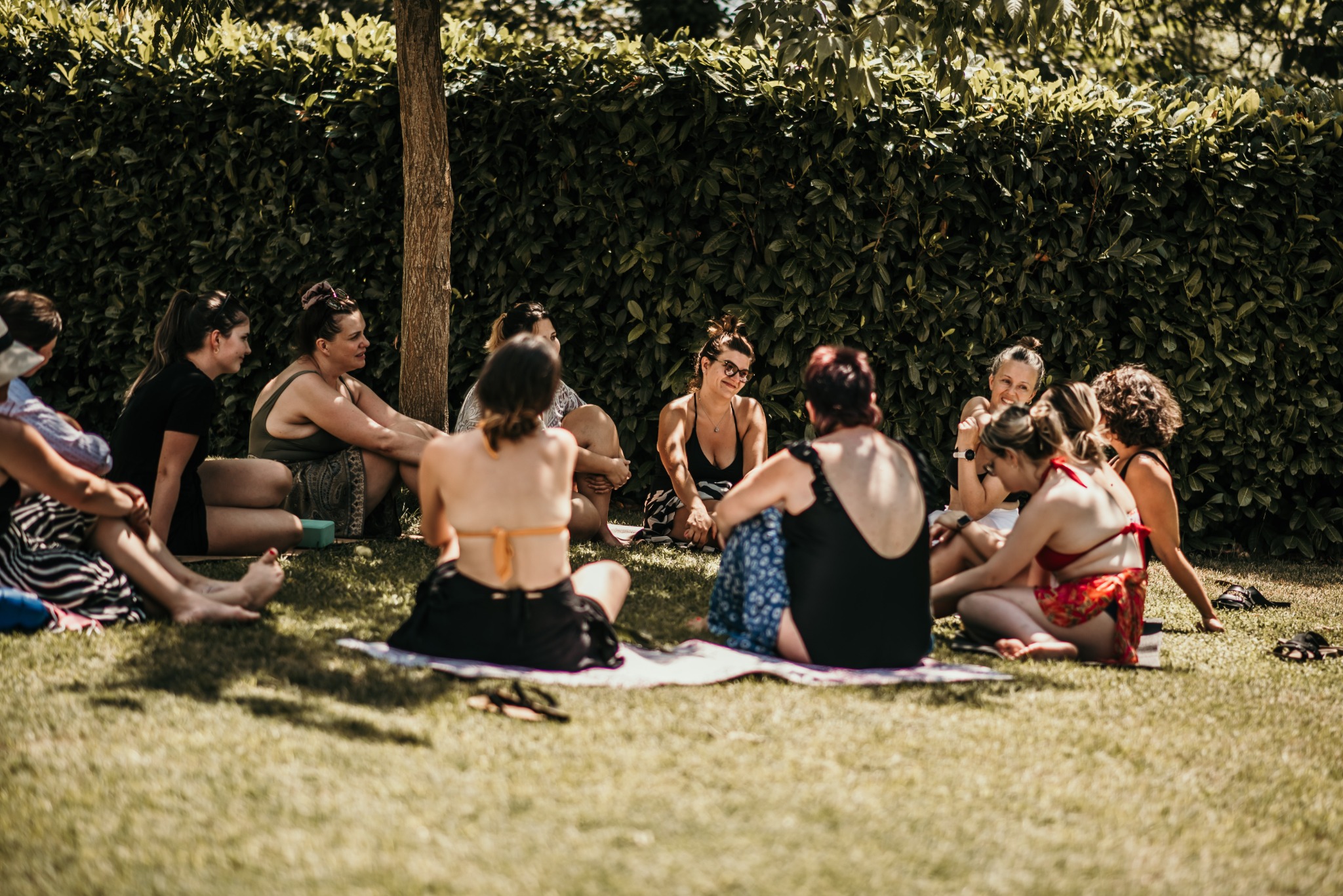 Women sitting in an outdoor conversation circle at a past gathering