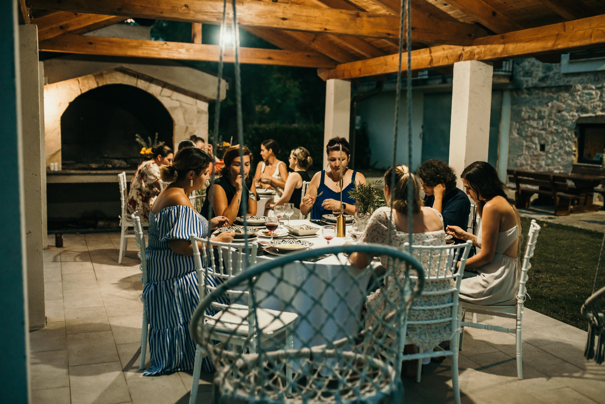 Women sharing an evening around an outdoor table at a past gathering